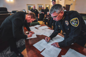 police officers signing dopcuments